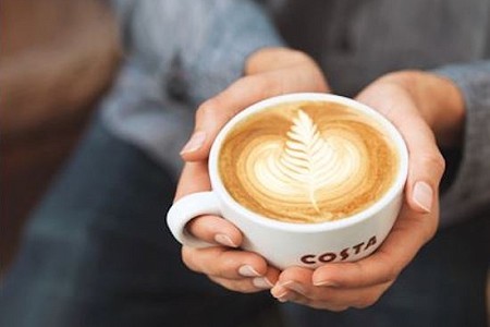 Person holding a coffee cup in both hands