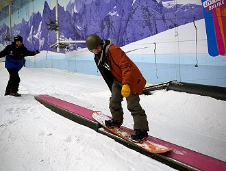 Snowboarder riding a box