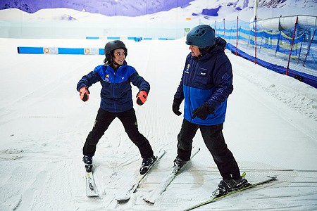 A group of women in ski gear taking part in a ski lesson