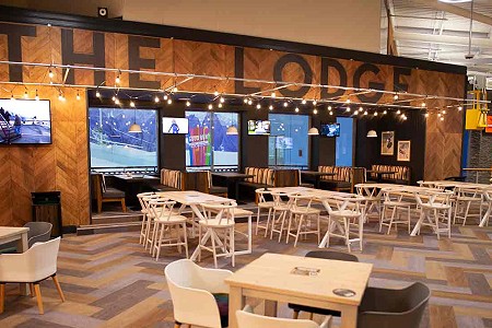 Seating area of the Lodge Bar & Kitchen overlooking the main slope at Chill Factor<sup>e</sup>